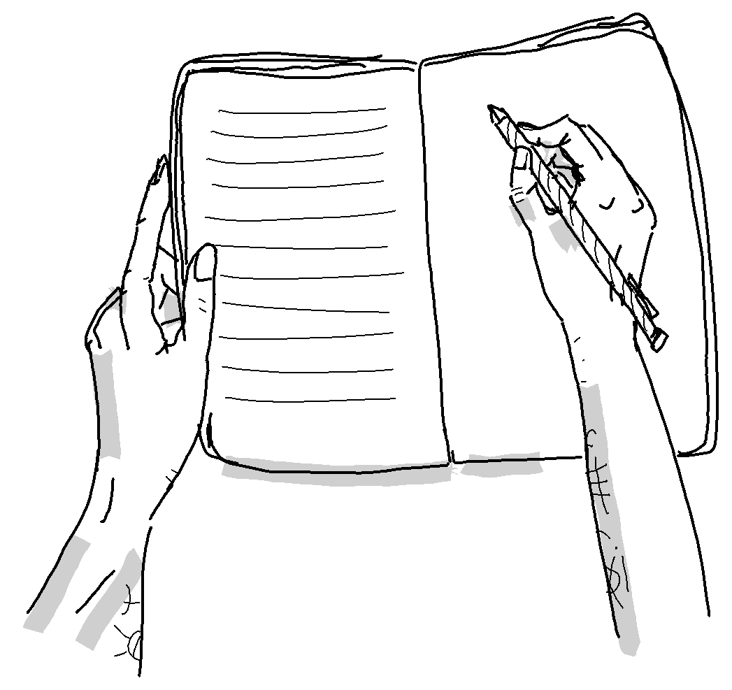 Deux mains en train d'écrire dans un cahier